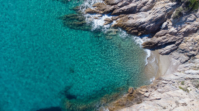 Aerial top view of Livadi Beach at the Ikaria island in a quiet summer day with blue clear water
