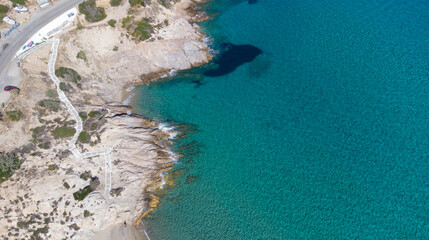 Aerial top view of Livadi Beach at the Ikaria island in a quiet summer day with blue clear water