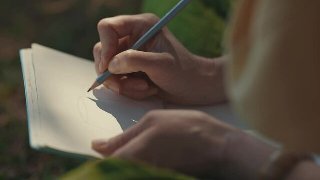 A woman drawing a jug with a pencil