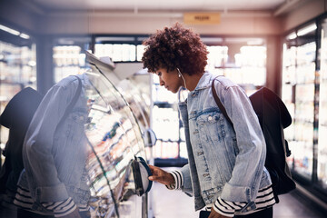 Young woman doing her grocery shopping in a supermarket