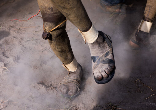 Bodi tribe fat men dancing in the dust during Kael ceremony, Omo valley, Hana Mursi, Ethiopia