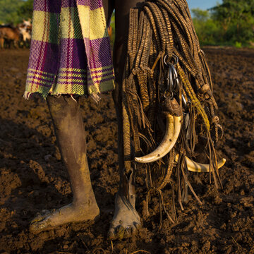 Bodi Tribe Kid, Holding Decorations For Cows Made With Warthog Teeth, Hana Mursi, Omo Valley, Ethiopia.