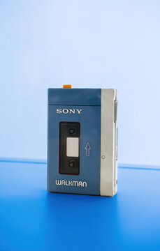 Schiltach, Germany - Jul 14, 2022: Contemporary image with sleek sony walkman cassette player electronic device on vibrant blue colored background. A symbol of retro style and obsolete technology.
