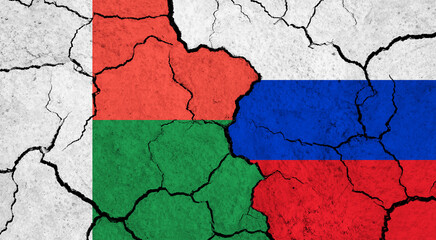 Flags of Madagascar and Russia on cracked surface - politics, relationship concept