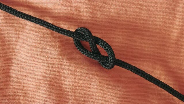 Make a knot with black rope