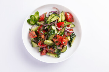 Salad of fresh cucumbers and tomatoes in a plate. selective focus.