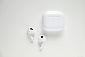 Wireless headphones and charging box on white background. Wireless bluetooth headphones in white...