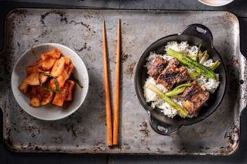 Mouthwatering Kalbi Delight: Top Close-Up of Delicious Grilled Kalbi on Steamed White Rice, Sizzling in a Cast Iron Pan, in 4K Resolution
