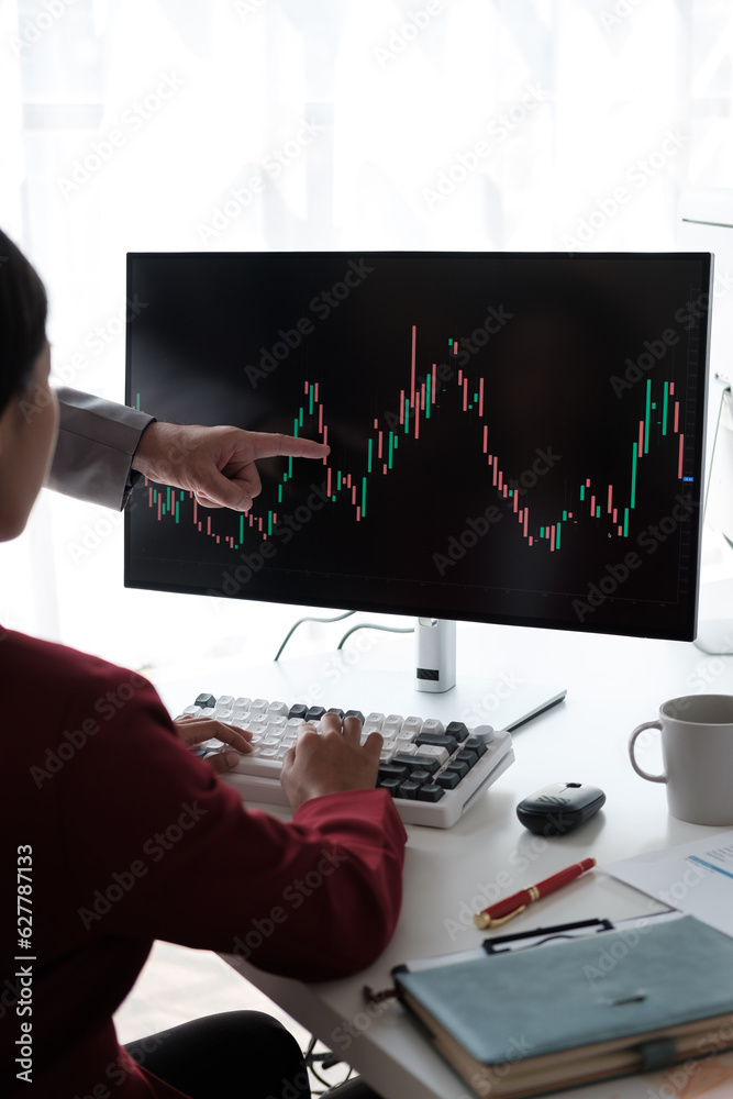 Poster close up view of young business team analyzing the stock market trend, focusing on computer monitor.