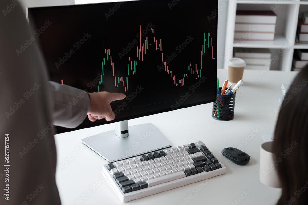 Poster close up view of young business team analyzing the stock market trend, focusing on computer monitor.
