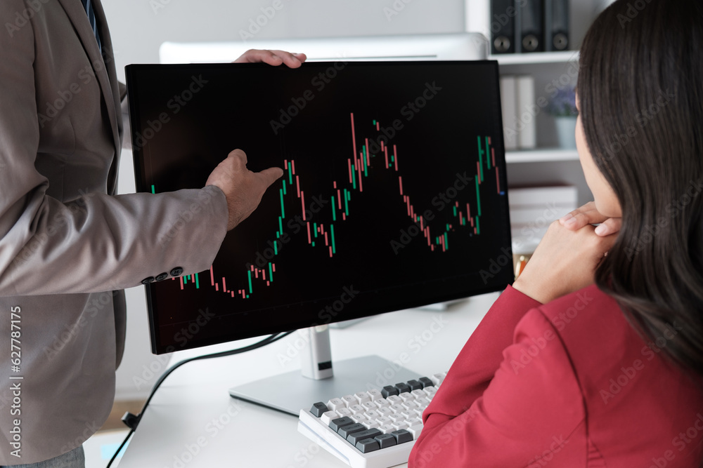 Poster close up view of young business team analyzing the stock market trend, focusing on computer monitor.