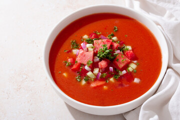 Spanish tomato and watermelon gazpacho cold soup styled and decorated in white plate