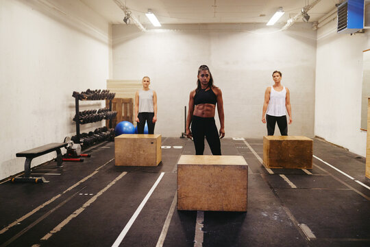 Diverse women ready for box jump class at the gym
