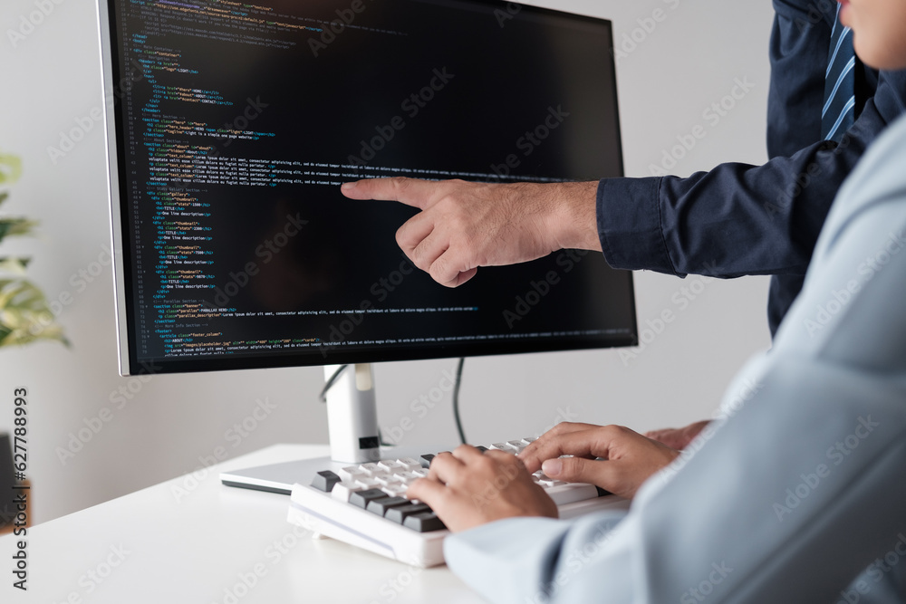 Poster Team of programmer pointing to desktop computer with developing programming code, trying to solve the problem.