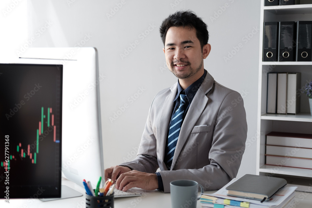 Aufkleber middle aged asian businessman analyzing investment trending, working on the computer in his office r