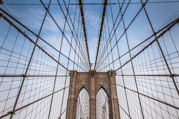 Iconic Brooklyn Bridge architectural close up with steel wires.