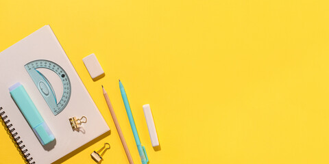 School supplies on yellow background. Back to school concept. Top view. Copy space.