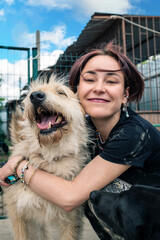 Dog at the shelter. Animal shelter volunteer takes care of dogs.