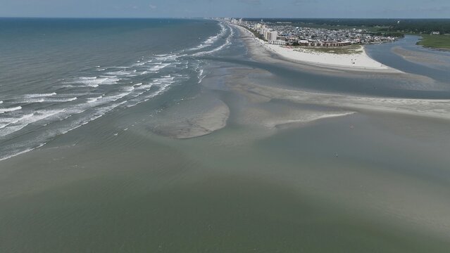 Vast sandbar at North end of Cherry Grove Beach where people sunbath on beautiful beach while on summer vacation at North Myrtle Beach in South Carolina