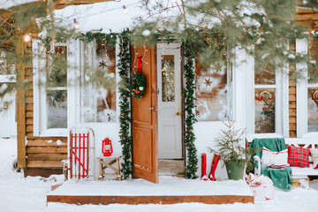 front door porch of village countryside house with swing hammock decorated for Christmas winter...