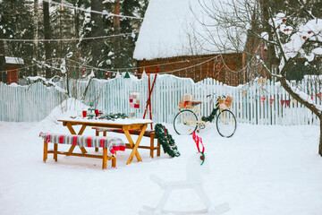 table near front door porch of village countryside house with swing hammock decorated for Christmas winter holidays, Christmas and New year vacation concept