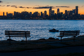 Colorful Seattle Sunrise Across Elliott Bay. Seen from West Seattle this modern city sparkles just before the sun rises above the horizon. 