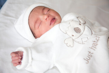 Newborn girl in the hospital on the day of her birth