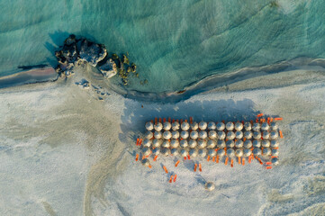 Elafonissi beach in Crete topdown shot, with beach umbrellas.