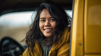 young adult woman is a postwoman by profession, and sits in a van on the driver's side at the steering wheel, open driver's door, when getting out, winter clothes