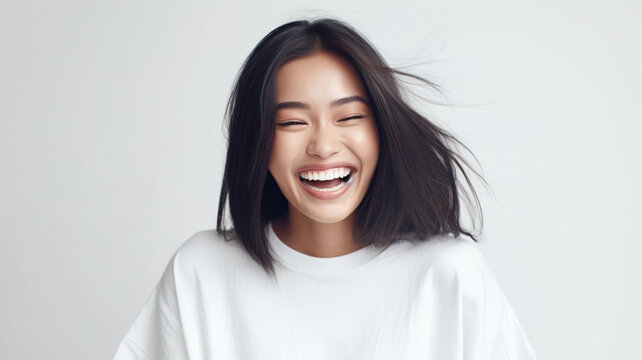 young adult woman laughs heartily, extreme positive emotions and feelings, femininity, hearty laughter, witty through joke or good mood