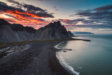 Dramatic sunset sky over Vestrahorn mountain and black sand beach in Stokksnes peninsula at Iceland