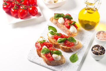 Tomato, basil and mozzarella cheese fresh made caprese bruschetta. Italian tapas, antipasti with...