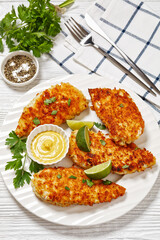 fried chicken cutlets on white plate, top view