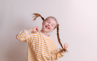 Portrait of a young excited shocked crazy smiling baby girl isolated on a white background