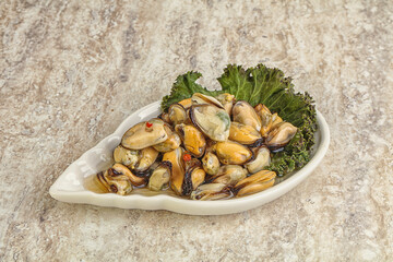 Tasty marinated mussels in the bowl