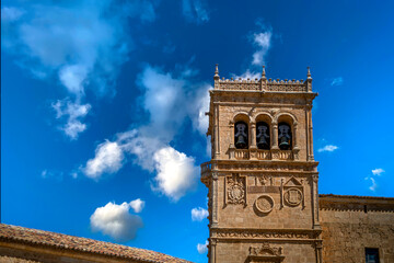 Horizontal view of the beautiful plateresque tower of the church of Morón de Almazan, in Soria, Spain, with intense blue sky in the background