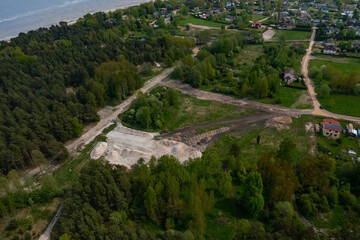 Top drone view of construction site in forest. White sand. Nature of Jurmala. Baltic sea.