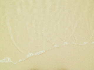 Sea water on sandy beach sand - nature background.