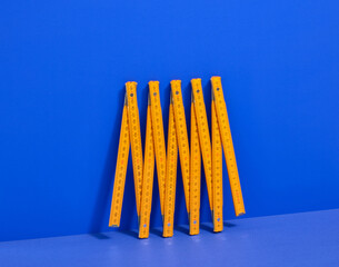 Folding ruler on a blue background. DIY construction tools.