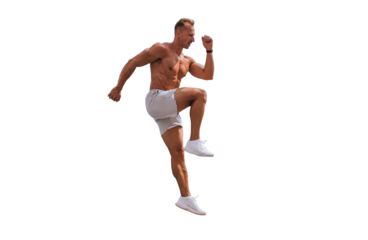 Jumping caucasian young adult bodybuilder jumping against transparent background. Muscular American man in shorts and sneakers warming up at workout. Fitness, sport, active people.