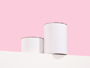 Two white cans of different sizes of paint. House renovation concept.