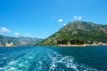 yacht trip in the Bay of Kotor, Montenegro, bright sunny day, mountains and palm trees, travel