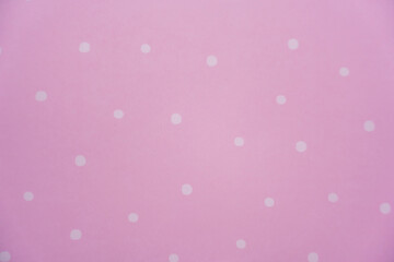 White polka dot on pink background. Paper pattern