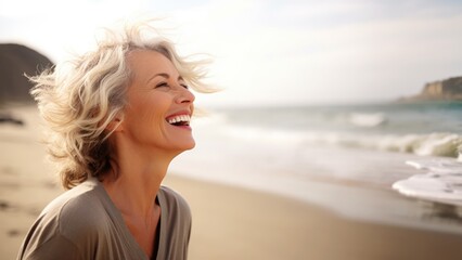 Laughing attractive mature senior woman looking away in the coast