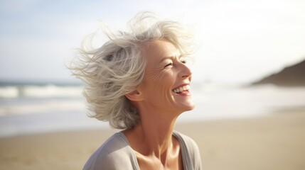 Fototapeta na wymiar Laughing attractive mature senior woman looking away in the coast