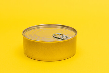 Unopened Tin Can with Blank Edge on Yellow Background. Canned Food. Aluminum Can for Safe and Long Term Storage of Food. Steel Sealed Food Storage Container
