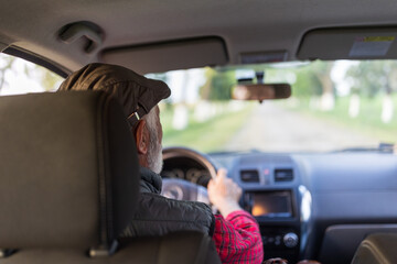 Senior man driving car