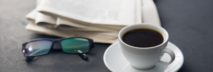 Obraz na płótnie Canvas glasses on newspapers with coffee