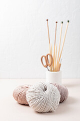 Craft knitting hobby background with yarn in natural colors. Recomforting hobby to reduce stress...