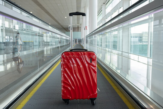 red baggage on wheels at airport